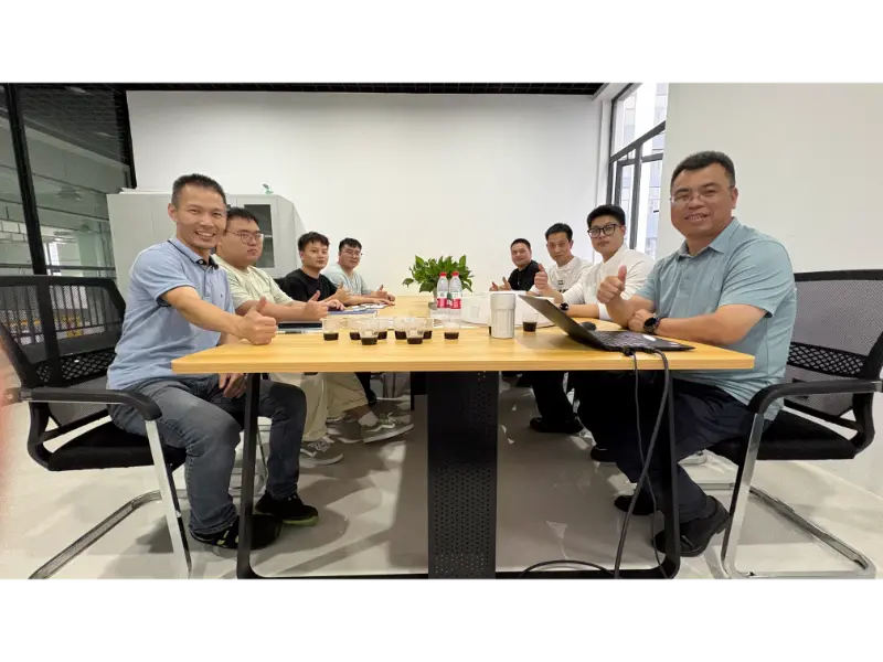 Team members and visiting clients take a group photo after the in-depth meeting.